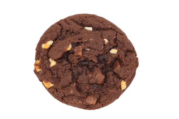 Chocolate cookies One homemade round shaped chocolate cookie with chocolate pieces isolated on a white background with a close up, top view. chocolate chip cookie top view stock pictures, royalty-free photos & images