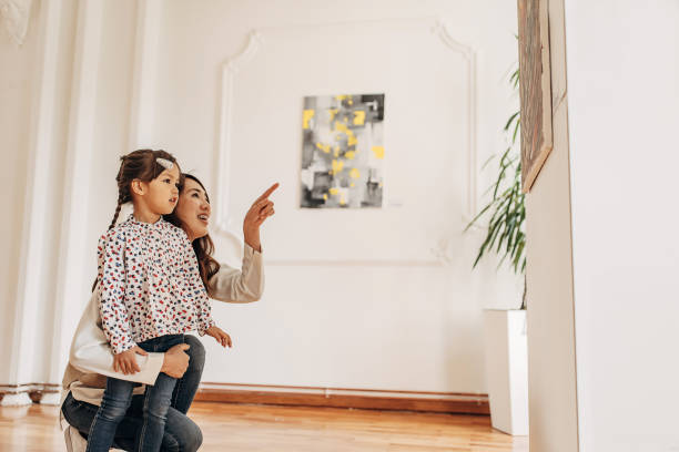 istock Mother and daughter in art gallery 1399039165