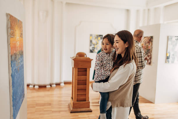istock Mother and daughter in art gallery 1399039201