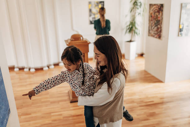 istock Mother and daughter in art gallery 1399039219