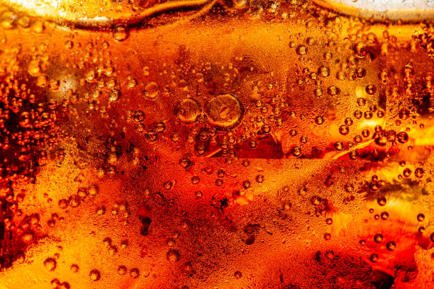 istock macro cola texture,cola with ice food background, cola close-up, design element. beer macro bubbles, ice, bubble, background, ice cubes, abstract backgrounds 1399040357