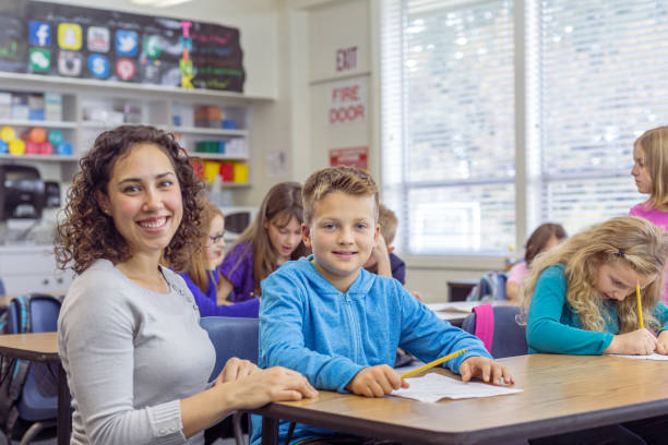istock Multiracial female teacher helping a student with an assignment during class 1399040805
