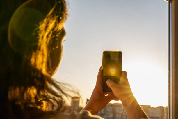istock Women taking sunset pictures with smartphone 1399041681