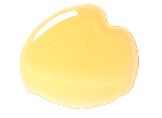 istock Puddle of honey isolated over white background. 1399044797