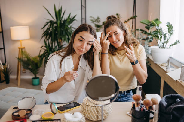istock Two happy girls applying make up at home 1399046158