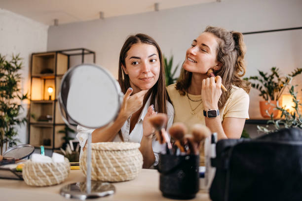 istock Two happy girls applying make up at home 1399046492