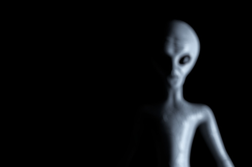Blurred Background Scary Gray Humanoid Alien on a black background. 3d Rendering