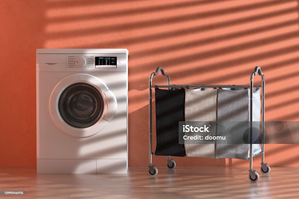 Empty Compartiments Laundry Clothing Separation Trolley Cart Room Service Tool and Equipment Near Modern White Washing Machine. 3d Rendering Empty Compartiments Laundry Clothing Separation Trolley Cart Room Service Tool and Equipment Near Modern White Washing Machine in front of orange painted wall. 3d Rendering Appliance Stock Photo