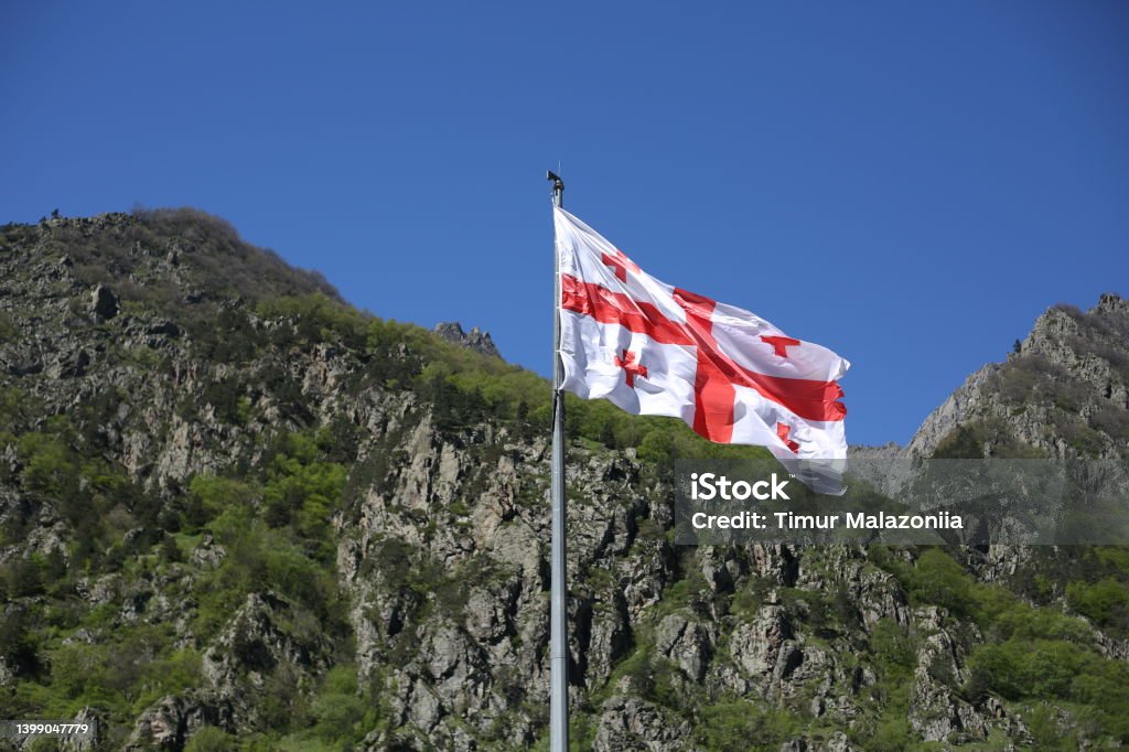 Georgian flag flutters in the wind on a sunny day Georgia - Country Stock Photo