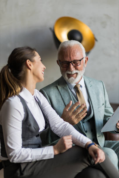 istock Two businesspeople having a laugh at work 1399049261