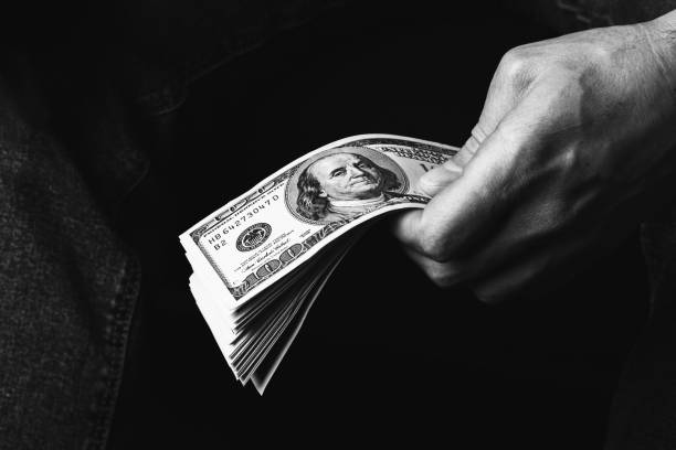 istock Male hand holding us hundred dollars banknotes 1399050215