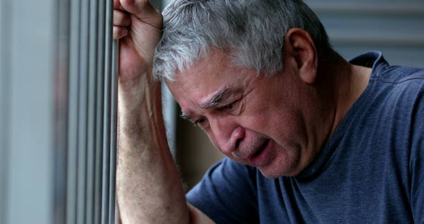 Crying older senior man. Depressed sad elder retired person stock photo