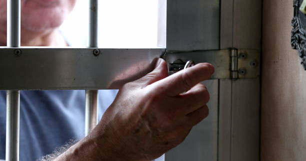 istock Man arriving home removing lock from home gate entrance 1399053952
