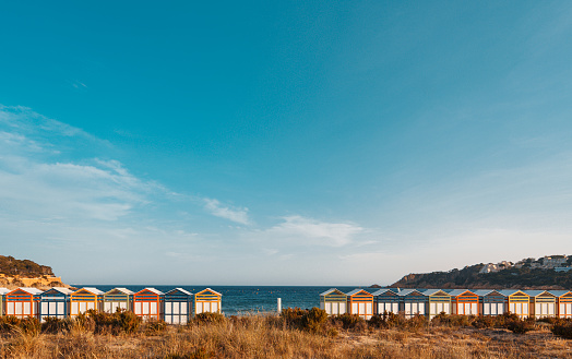 Famous beach huts in Sagaro with Playa de Sant Pol, Costa Brava. Spain. Mediterranean Sea. The bathing huts date from the early 1920s