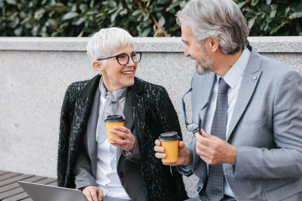 istock Business people in a suit holding coffee to go 1399054621
