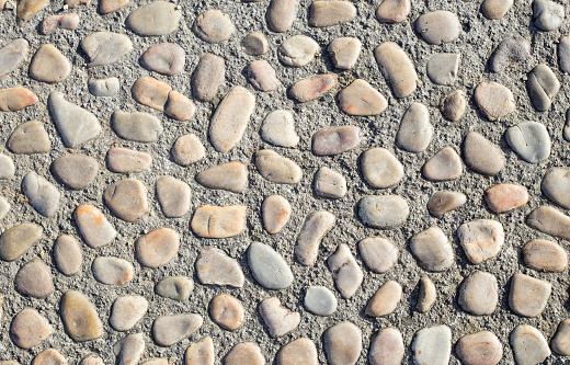 A Round stones forming a pathway. boulder roadway.