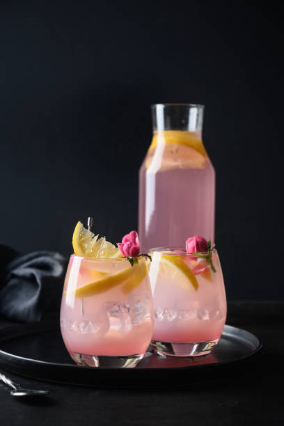 istock Cocktails with pink rose gin and lemon on black background. 1399056163