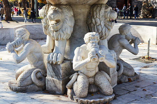 marble stylized fountain with antique figures in the city park. Almaty, Kazakhstan - October 24, 2021