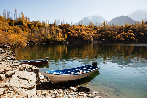 Scenic view of a boat at the Upper Kachura Lake in the Karakoram Mountains in the autumn