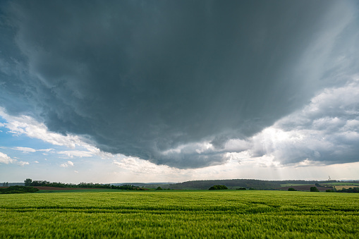 Rotating wall cloud (mesocyclone) of a supercell thunderstorm over the landscape of The Eifel, Germany.