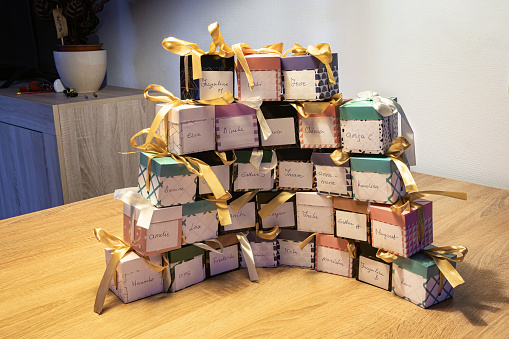 Stack of gift boxes with people's names written on them.