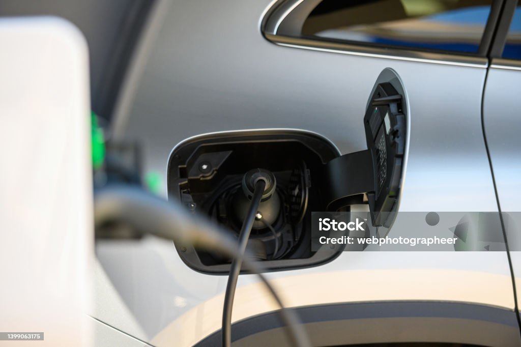 Electric vehicle at charging station Electric vehicle charging to electrical car, plugged in, Nikon Z7 Car Stock Photo