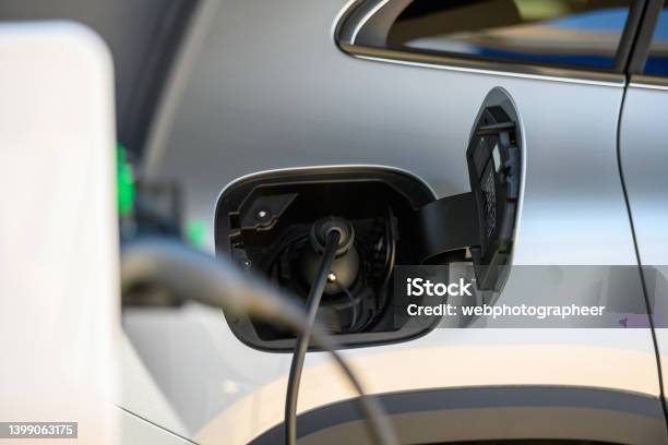Electric Vehicle At Charging Station Stock Photo - Download Image Now - Car, Electronics Industry, Alternative Fuel Car