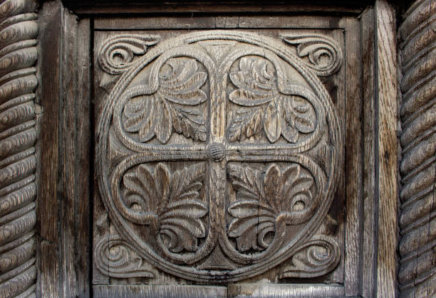 istock weathered wooden ornament with engraved decorative natural motifs inside a circle - old lacework on a door of wood with a frame for an ancient background 1399063898