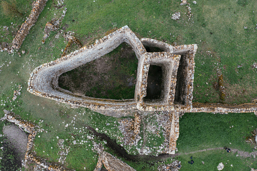 Old ruined castle Frigate in the misty mountains, aerial view.