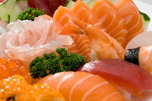 Set of sushi and maki with soy sauce over black background. Top view with copy space