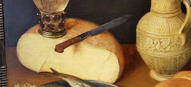 Cheese, knife with a jug next to it