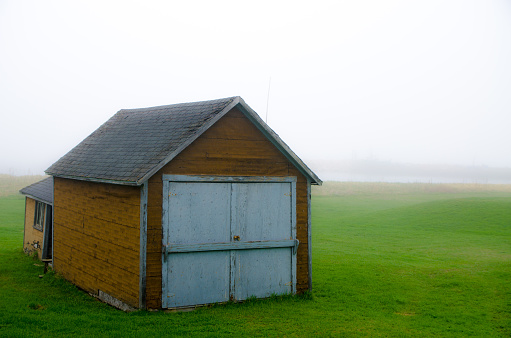 Small shack in the morning fog during springtime