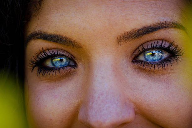 Close up on a girl blue eye, panoramic web banner with copy space