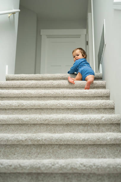 istock Baby boy crawling up at stairs 1399076445
