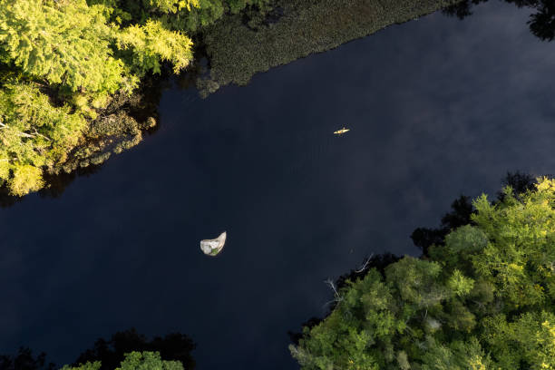 istock New Hampshire: Aerial View of a River in a Forest With Kayaker 1399082929
