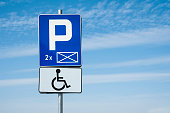 Symbol of wheelchair on a road sign. Disability reserved zone in the car park.