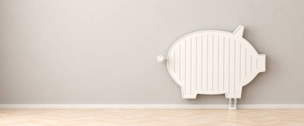 Saving heat energy concept. A radiator in the form of a piggy bank. Copy space available - web banner format. stock photo