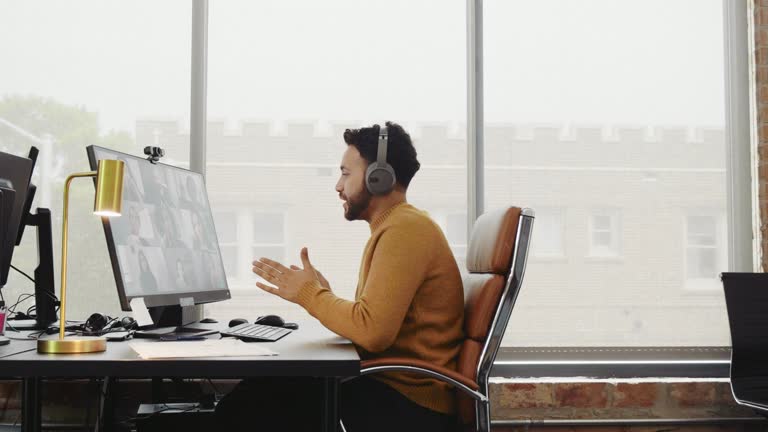 Businessman updates colleagues during virtual meeting