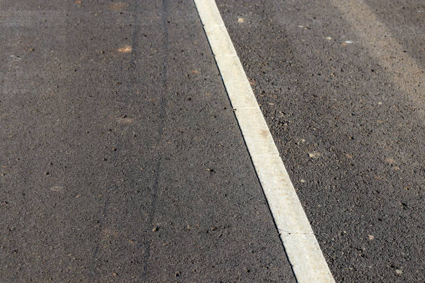 istock close up of white line on bitumen road 1399089232