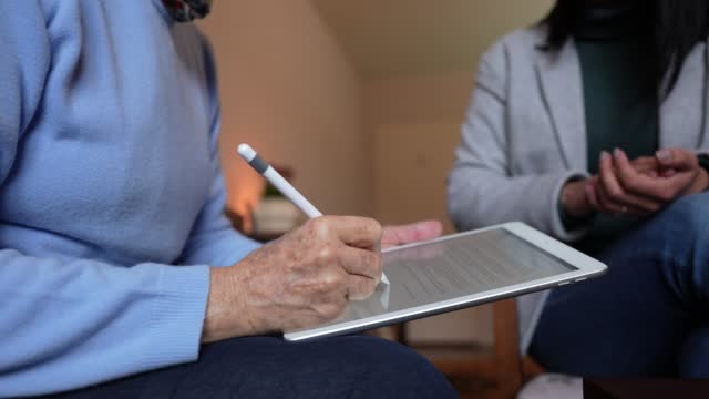 Elder woman signing a digital contract
