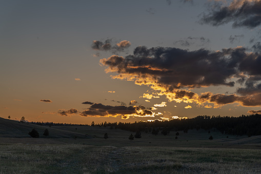 Sunset on northern Montana prairie at foot of mountains in northwestern USA.