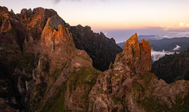 istock Huge rocky mountains under cloudy sunset sky 1399097301
