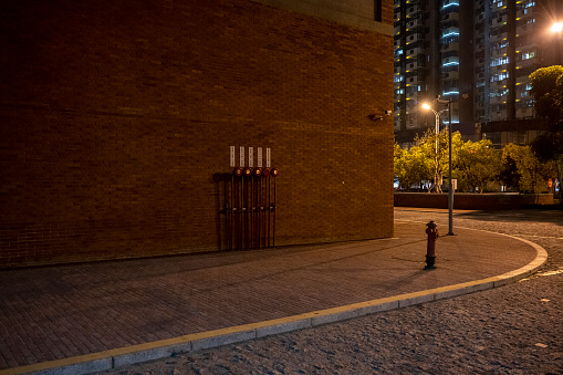 A sidewalk in a brick building at night