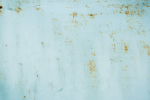Traces of corrosion and scratches on the iron surface. Rough texture of blue color.