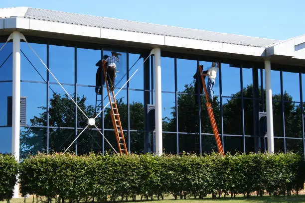 Two window cleaners at work
