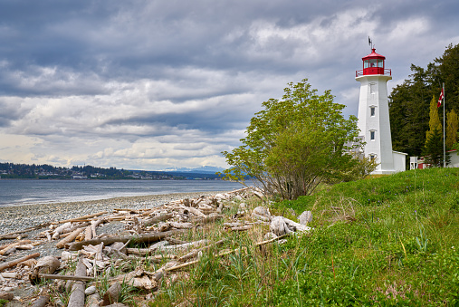 The Cape Mudge Lighthouse on Quadra Island overlooking Discovery Passage and Campbell River on the far shore. BC, Canada.
