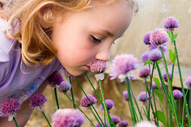 Young girl smelling flowers