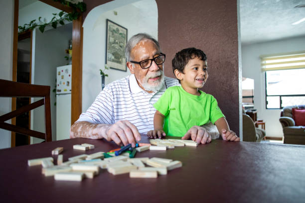 istock grandfather and grandson playing at home 1399108274