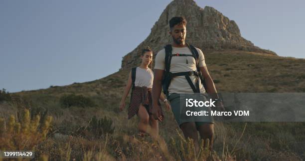 A Couple Hiking Up A Mountain On A Travel Adventure A Happy Young Man And Woman In Love Walking Through Nature Stock Photo - Download Image Now