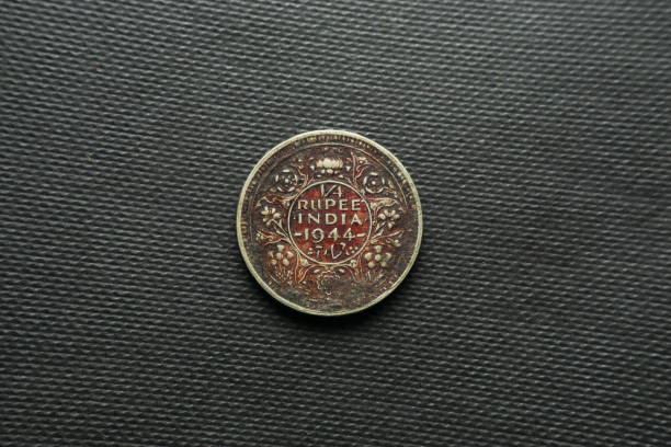 istock 1/4 Rupee coin dated 1944 India, Back view, King George, Silver reeded edge with groove 1399121453